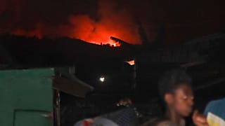 People flee as the night sky is turned red by the eruption of Mount Nyiragongo, in Goma, Congo, Saturday, May 22, 2021. 