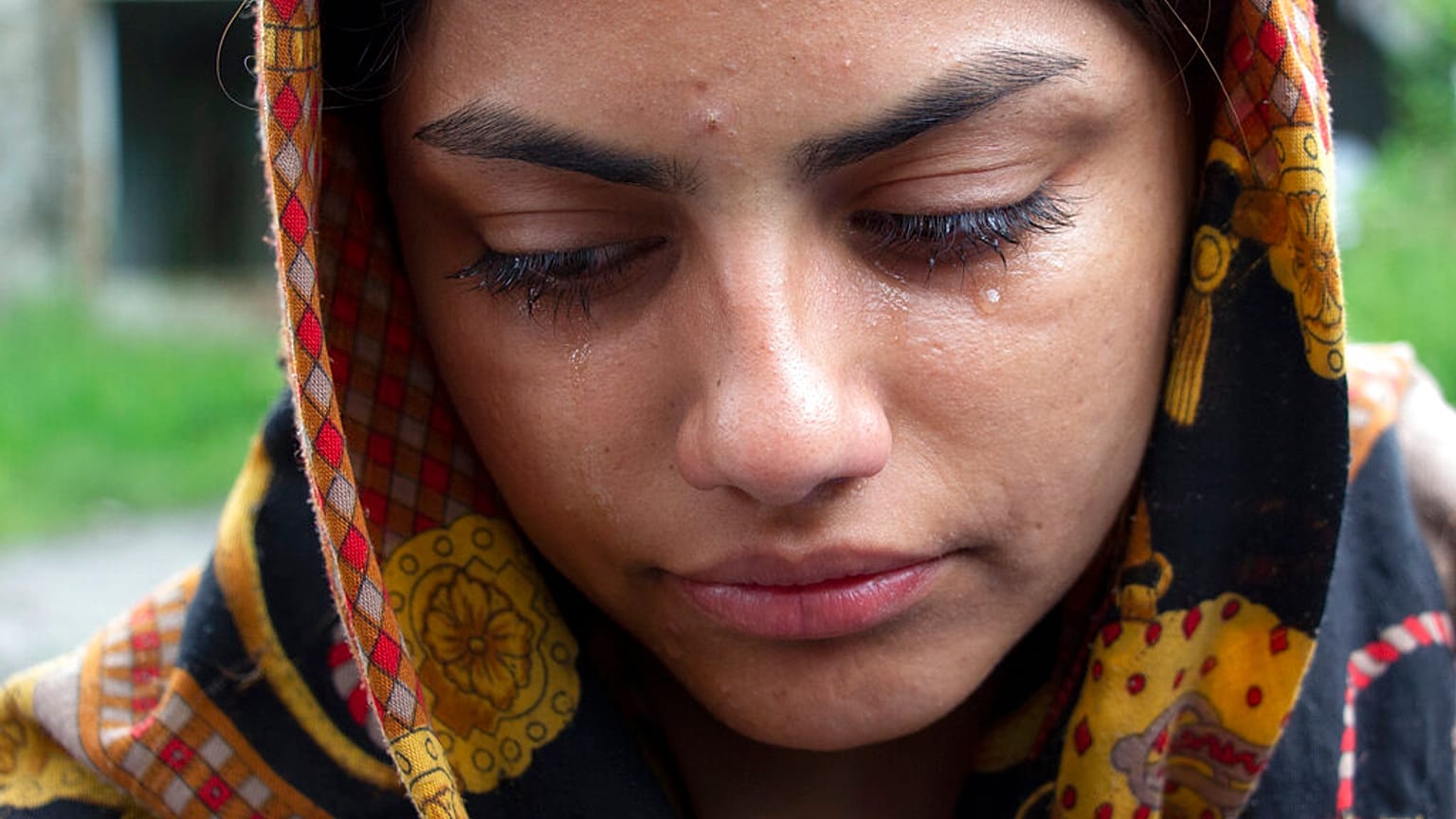 A woman from Afghanistan cries in the village of Bosanska Bojna, Bosnia, Saturday, May 22, 2021.