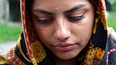 A woman from Afghanistan cries in the village of Bosanska Bojna, Bosnia, Saturday, May 22, 2021.