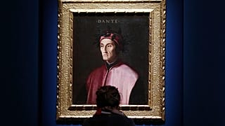 A woman looks at a portrait of poet Dante Alighieri at an exhibition, in Forlì, Italy, Saturday, May 8, 2021