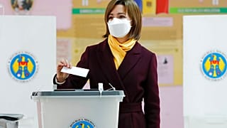 Former prime minister Maia Sandu prepares to cast her vote in the country's presidential election runoff in Chisinau, Moldova, Sunday, Nov. 15, 2020