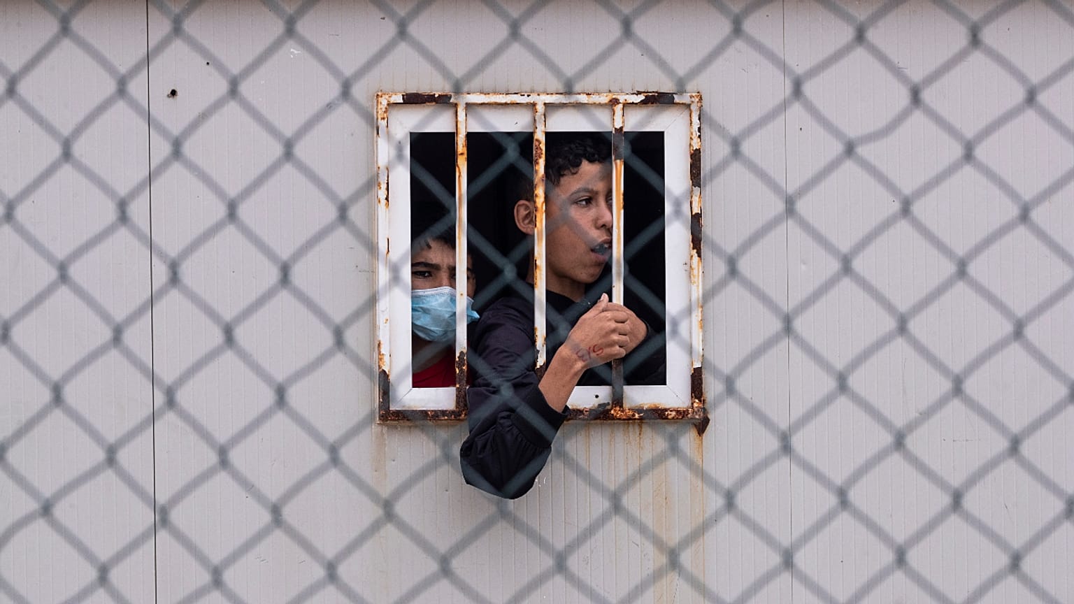 Children who crossed into Spain wait inside a temporary shelter in the enclave of Ceuta, next to the border of Morocco and Spain, Thursday, May 20, 2021.