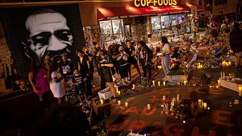 People take a knee at George Floyd memorial on anniversary of his death