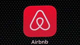 The Airbnb app icon is seen on an iPad screen