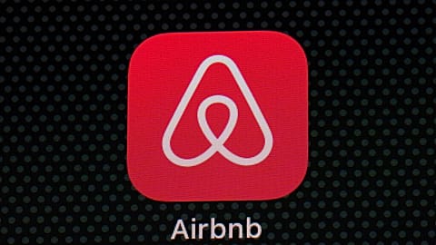 The Airbnb app icon is seen on an iPad screen