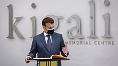 French President Emmanuel Macron speaks next to the visitor's book at the genocide memorial site in the capital Kigali, Rwanda 