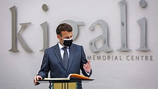 French President Emmanuel Macron speaks next to the visitor's book at the genocide memorial site in the capital Kigali, Rwanda 