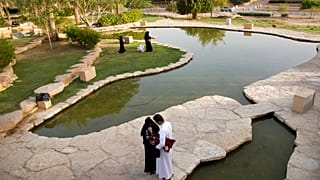 Visitors walk in a garden at the 18th century Diriyah fortified complex, that once served as the seat of power for the ruling Al Saud, in Riyadh, Saudi Arabia. 