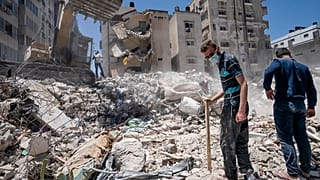 Heavy construction equipment is used to sift through rubble in Gaza City on Thursday, May 27, 2021.