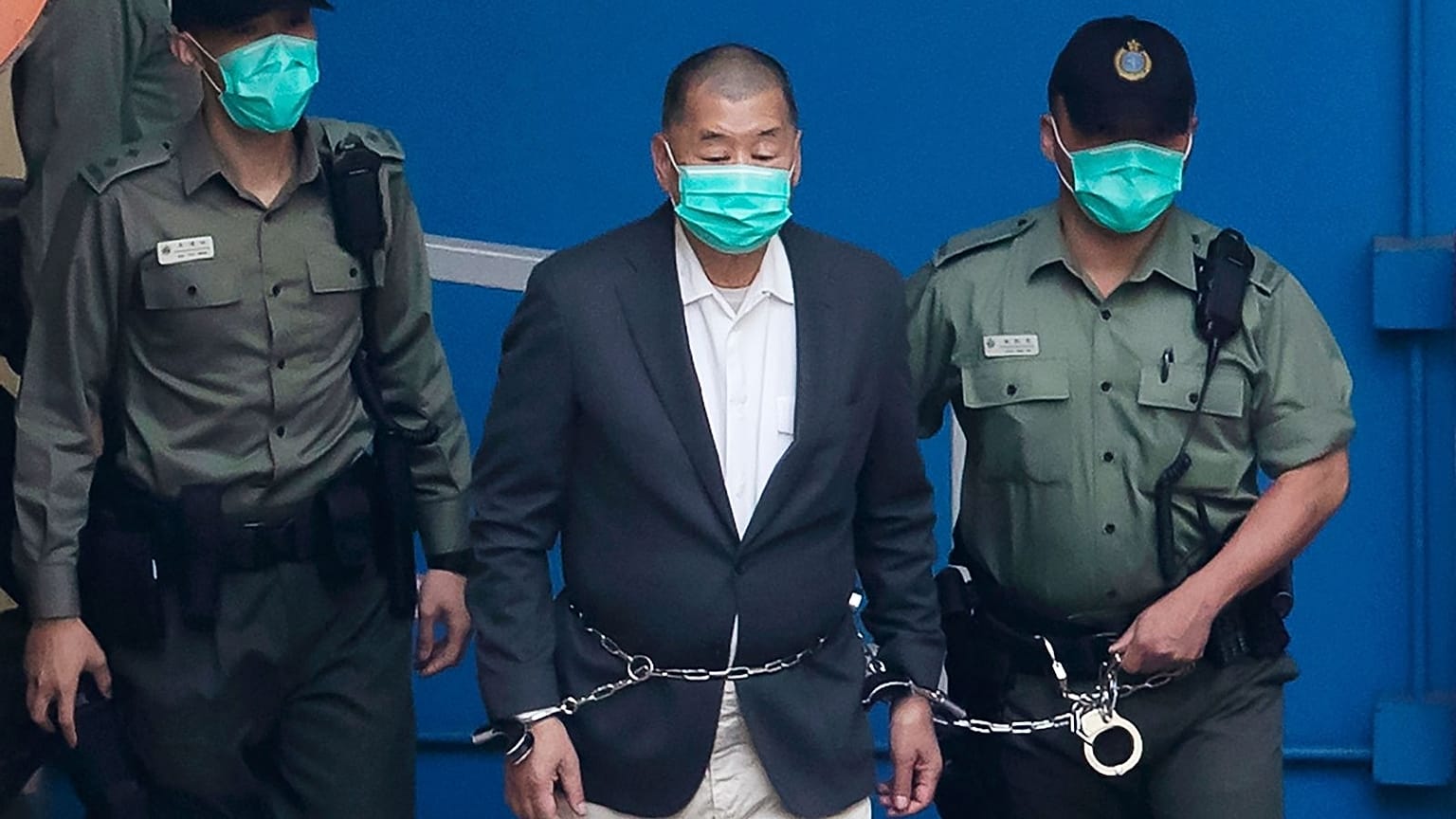 Jimmy Lai is escorted to get on a prison van, Hong Kong