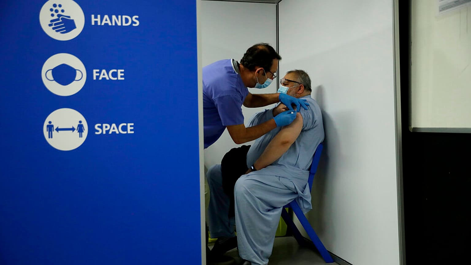 Maoula Jan, 52, who is British and originally from Afghanistan receives his second dose of the Pfizer vaccine at the Swaminarayan School in Neasden, north London, May 1, 2021.