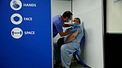 Maoula Jan, 52, who is British and originally from Afghanistan receives his second dose of the Pfizer vaccine at the Swaminarayan School in Neasden, north London, May 1, 2021.