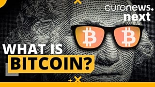 A person holds a visual representation of the digital cryptocurrency Bitcoin, at the "Bitcoin Change" shop in the Israeli city of Tel Aviv.