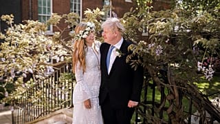 Britain's Prime Minister Boris Johnson and Carrie Johnson pose together in the garden of 10 Downing Street after their wedding on May 29, 2021.