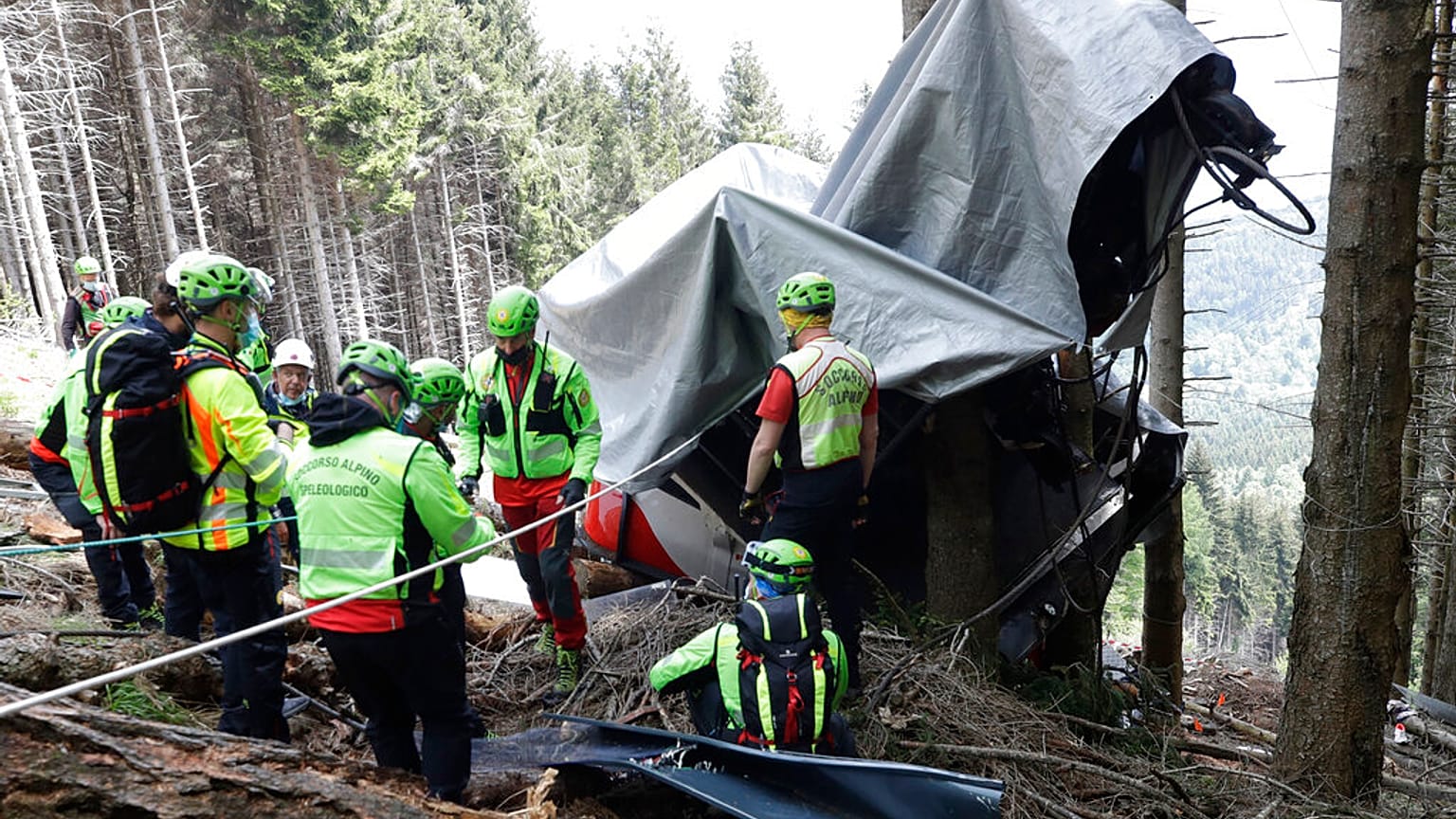 Rescuers search for evidence in the wreckage near the summit of the Stresa-Mottarone line in Piedmont on Wednesday 