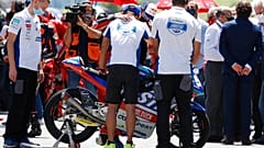 Teammates of 19 years-old Swiss racer Jason Dupasquier by his motorbike during a minute's silence on Sunday