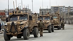 British soldiers with NATO-led Resolute Support Mission forces arrive at the site of an attack in Kabul, Afghanistan, March 25, 2020. 