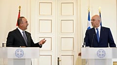 Greek Foreign Minister Nikos Dendias, right, and his Turkish counterpart Mevlut Cavusoglu 