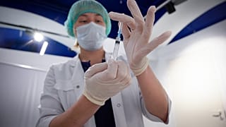 A healthcare worker prepares a dose of Russia's Sputnik V Covid-19 vaccine, at a vaccination centre in Moscow on April 26, 2021.