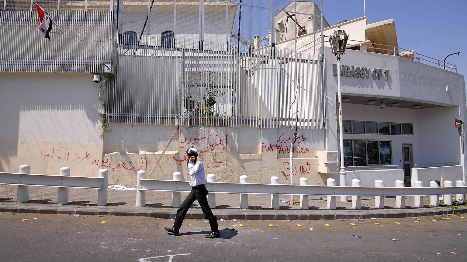 FILE: A policeman walks in front of the damaged US embassy after pro-government protesters attacked the embassy in Damascus, Syria, 2011