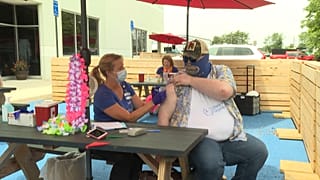 Man getting a Johnson & Johnson vaccine shot at Beltway Brewing.