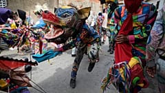Personas vestidas con trajes de diablo celebran la fiesta católica del Corpus Christi en Naiguatá, Vargas, Venezuela, el 3 de junio de 2021.