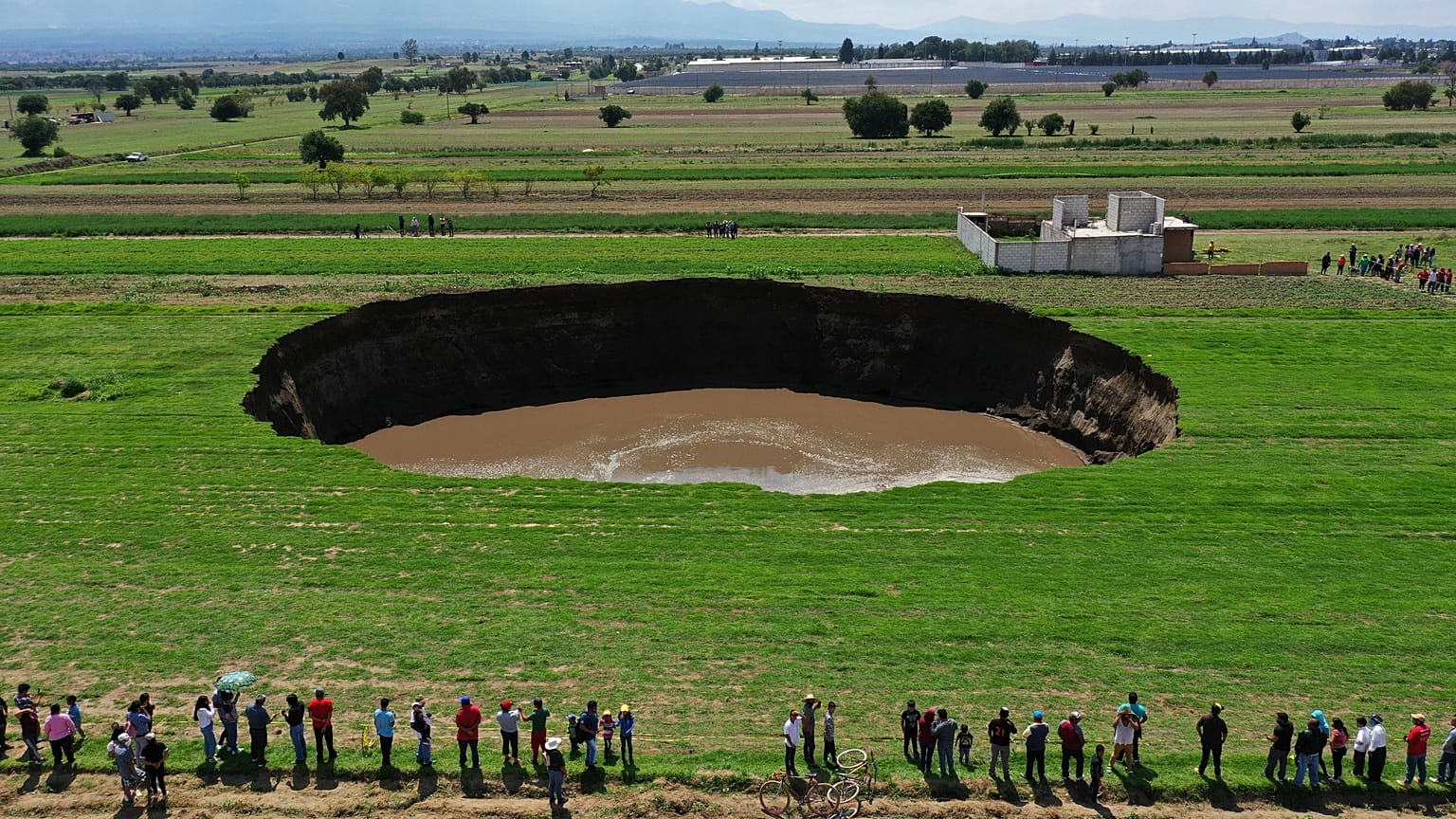 Aerial view of a sinkhole that was found by farmers in a field of crops in Santa Maria Zacatepec, state of Puebla, Mexico. May 30, 2021