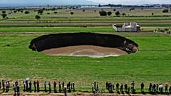 Aerial view of a sinkhole that was found by farmers in a field of crops in Santa Maria Zacatepec, state of Puebla, Mexico. May 30, 2021