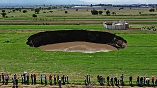 Aerial view of a sinkhole that was found by farmers in a field of crops in Santa Maria Zacatepec, state of Puebla, Mexico. May 30, 2021