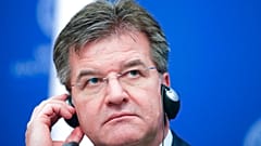 In this file photo dated Tuesday, Feb. 18, 2020, Slovakia's Foreign Minister Miroslav Lajcak adjusts his headphones during a press conference in Bucharest, Romania. 