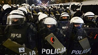 The symbol for Women's Strike has been stuck to the riot shield of a police officer during a protest against the verdict restricting abortion rights in Warsaw, Poland