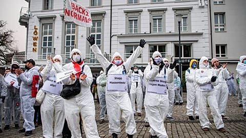 Demonstrators in Zug, Switzerland, protest against the COVID-19 measures enforced by the government on Saturday, February 6, 2021.