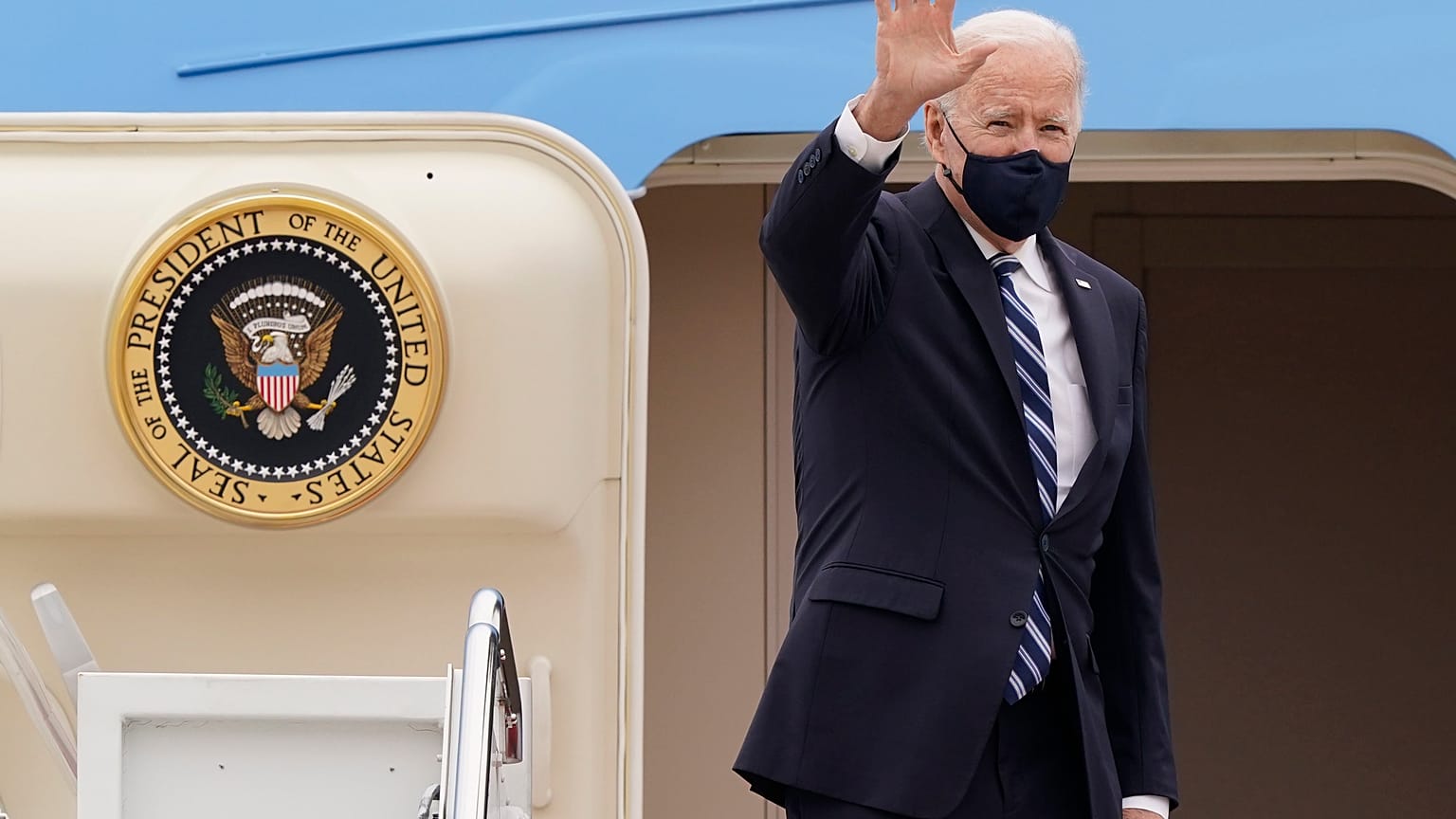 US President Joe Biden waves from the top of the steps of Air Force One at Andrews Air Force Base, on March 16, 2021. 
