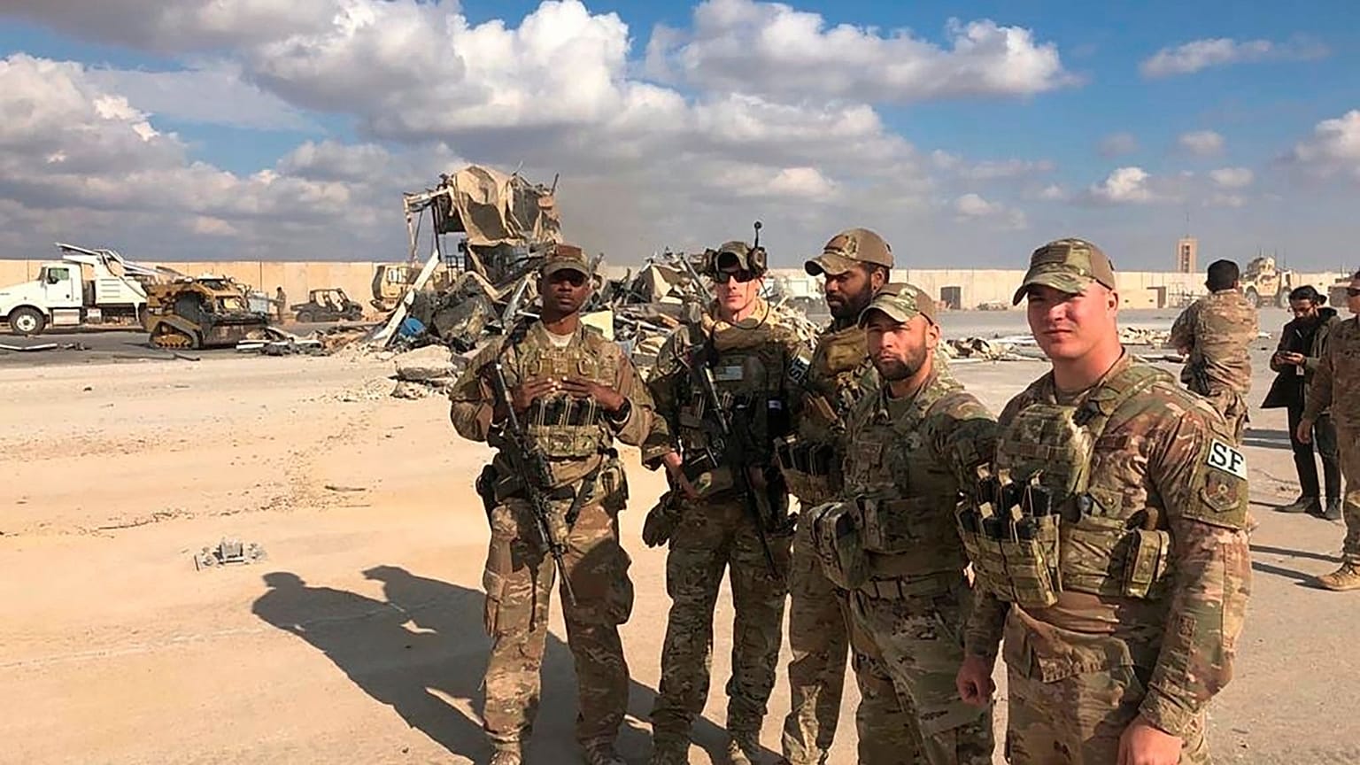 U.S. Soldiers stand at a site of Iranian bombing at Ain al-Asad air base