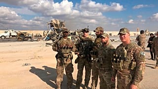 U.S. Soldiers stand at a site of Iranian bombing at Ain al-Asad air base