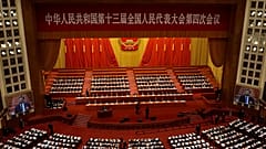 Delegates attend the opening session of China's National People's Congress (NPC) at the Great Hall of the People in Beijing on March 5, 2021.