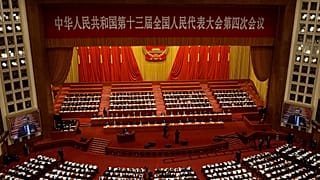 Delegates attend the opening session of China's National People's Congress (NPC) at the Great Hall of the People in Beijing on March 5, 2021.