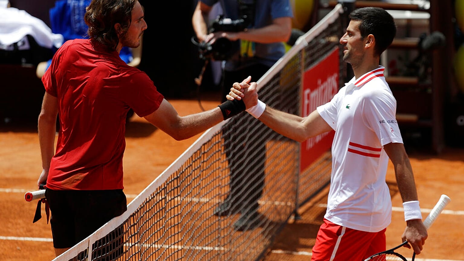 Serbia's Novak Djokovic greets Greece's Stefanos Tsitsipas, left