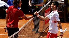 Serbia's Novak Djokovic greets Greece's Stefanos Tsitsipas, left