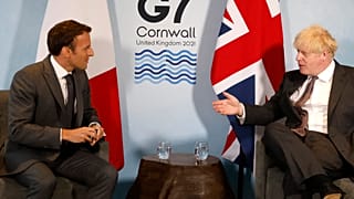 Britain's Prime Minister Boris Johnson and France's President Emmanuel Macron take part in a bilateral meeting during the G7 summit in Carbis bay, Cornwall on June 12, 2021.