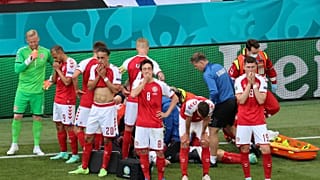 Denmark's players react as their teammate Christian Eriksen lays injured on the ground during the Euro 2020 soccer championship group B match between Denmark and Finland,