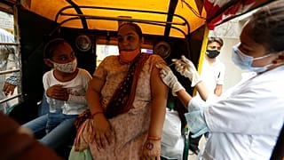 A physically disabled woman gets a dose of Covishield, Serum Institute of India's version of the AstraZeneca COVID-19 vaccine, in Ahmedabad, India, Saturday, June 12, 2021.