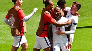 England's Raheem Sterling, centre, is congratulated by teammates after scoring his team's first goal during Euro 2020
