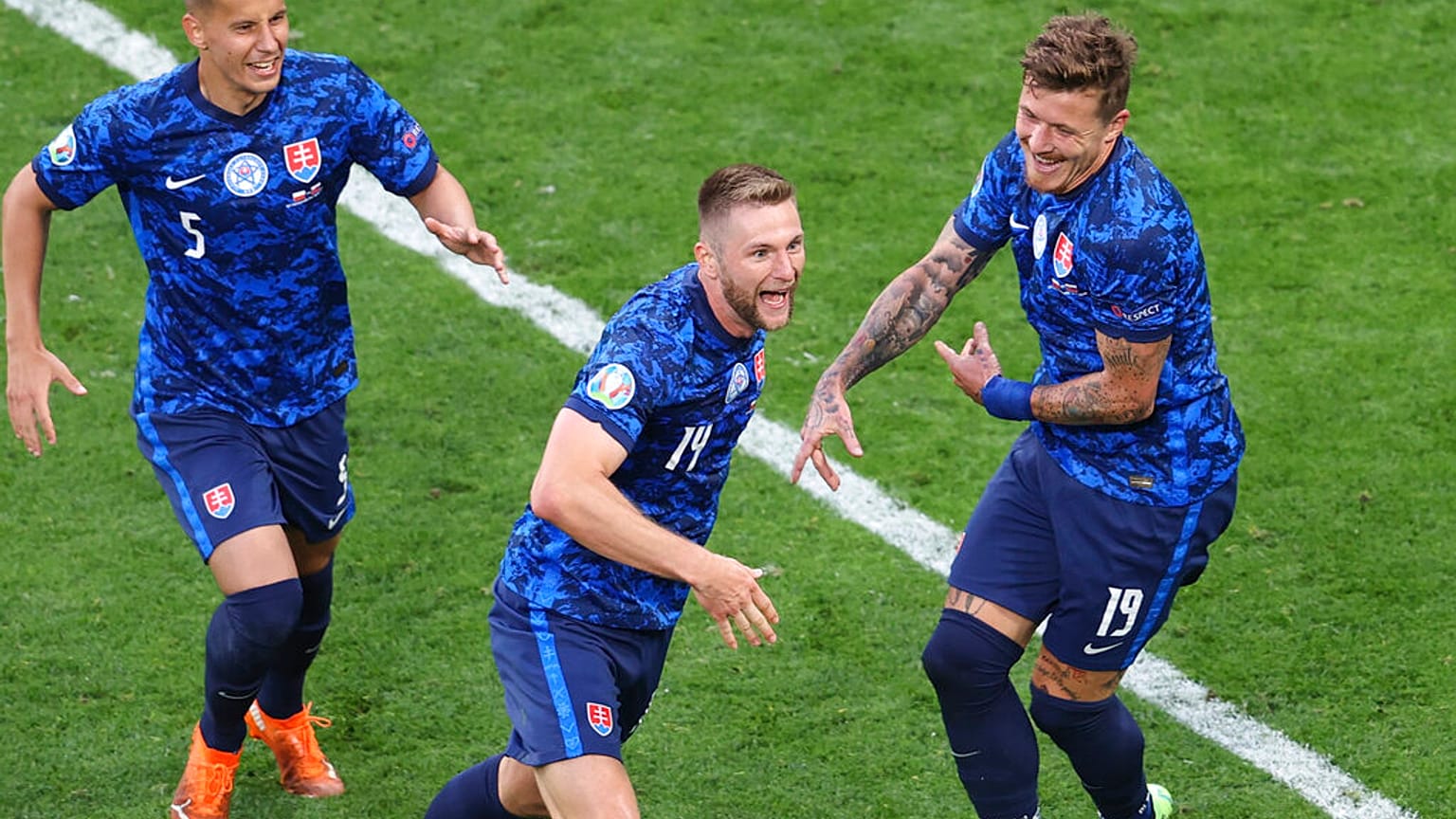 Slovakia's Milan Skriniar, centre, celebrates after scoring his side's second goal during the Euro 2020 soccer championship group E match between Poland and Slovakia