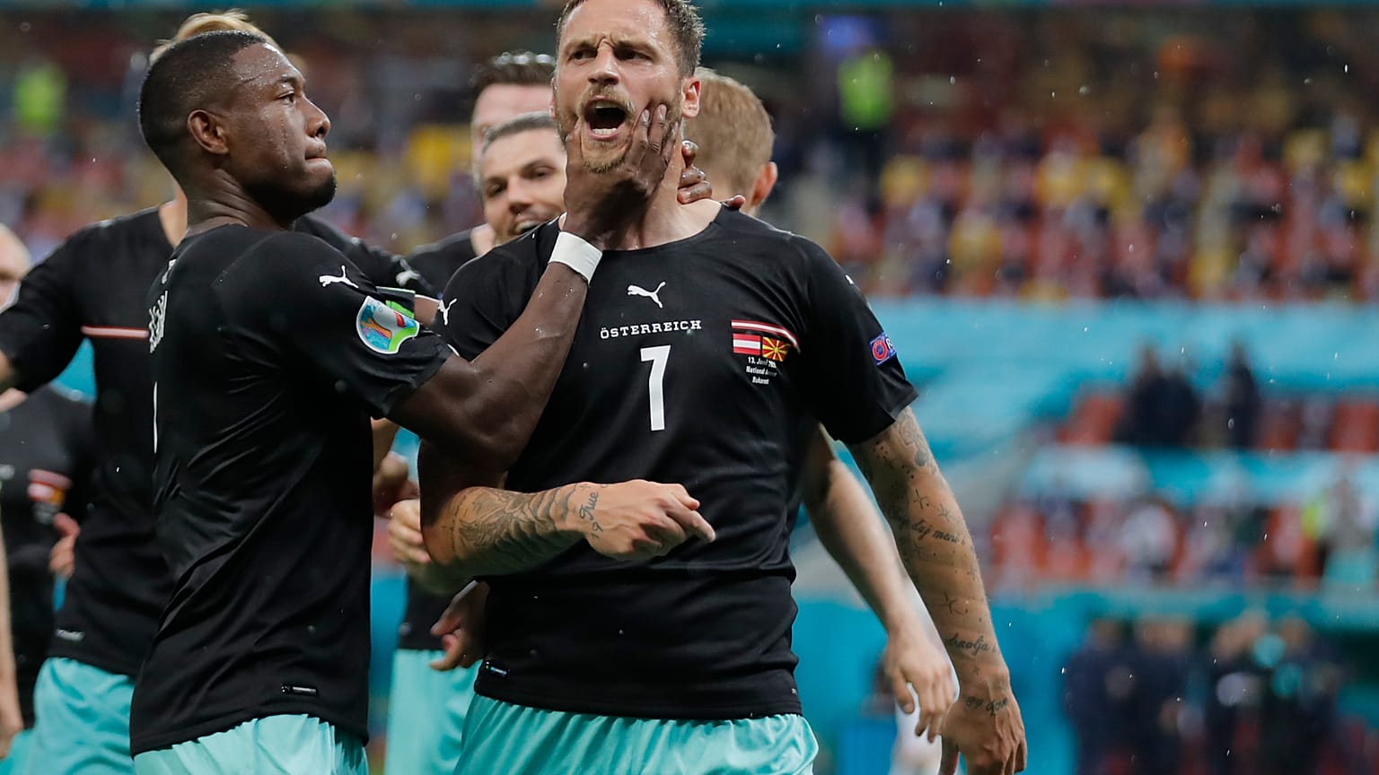 Marko Arnautovic (right) celebrates with his Austrian teammates after scoring during Sunday's UEFA Euro 2020 group match against North Macedonia.
