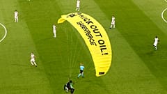 A Greenpeace paraglider lands at the Allianz Arena stadium in Munich prior to the Euro 2020 group F match between France and Germany, June 15, 2021