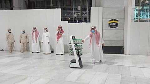 A smart robot with bottles of Zamzam water to reduce direct contact with staff to prevent COVID-19 infections during the yearly hajj pilgrimage.