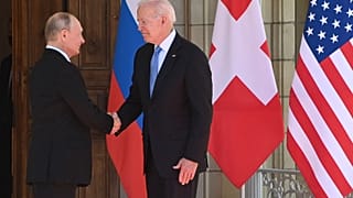 Russian President Vladimir Putin (L) shakes hands with US President Joe Biden prior to the US-Russia summit at the Villa La Grange, in Geneva on June 16, 2021. 