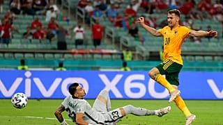 Wales' Aaron Ramsey, right, scores his sides first goal past Turkey's goalkeeper Ugurcan Cakir