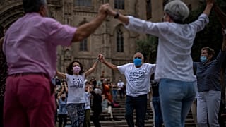 People wearing face masks to protect against COVID-19 perform a traditional Catalan dance in Barcelona, Spain, on June 5, 2021.